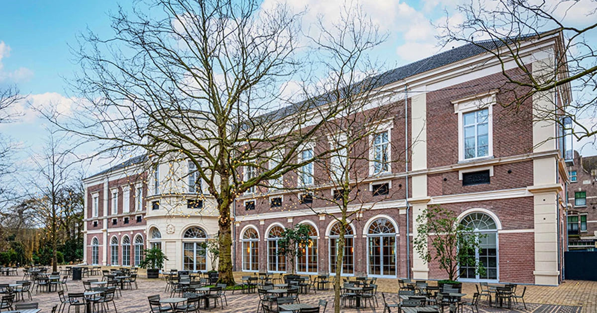 Historic architecture of the Artis Groote Museum in Amsterdam featuring 19th-century design elements, arched windows, and classical detailing

