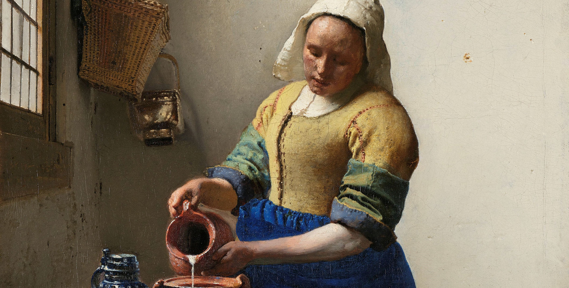 The Milkmaid by Johannes Vermeer depicting a woman pouring milk in a sunlit kitchen, showcasing detailed textures and quiet domesticity

