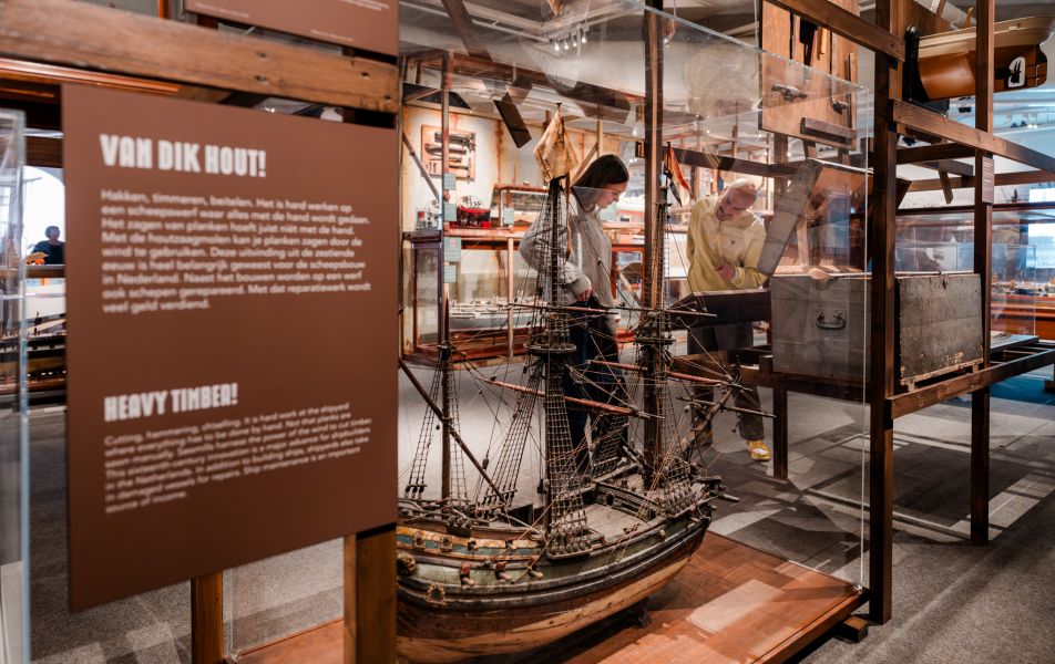 Exhibit on trade and innovation at the Maritime Museum Rotterdam showing interactive displays, shipping models, and technological advancements in maritime logistics

