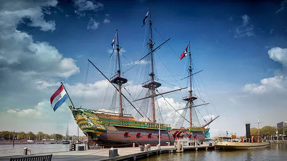 Replica of a 17th-century Dutch East India Company (VOC) ship docked outside the Scheepvaartmuseum Amsterdam, showcasing maritime heritage and naval architecture

