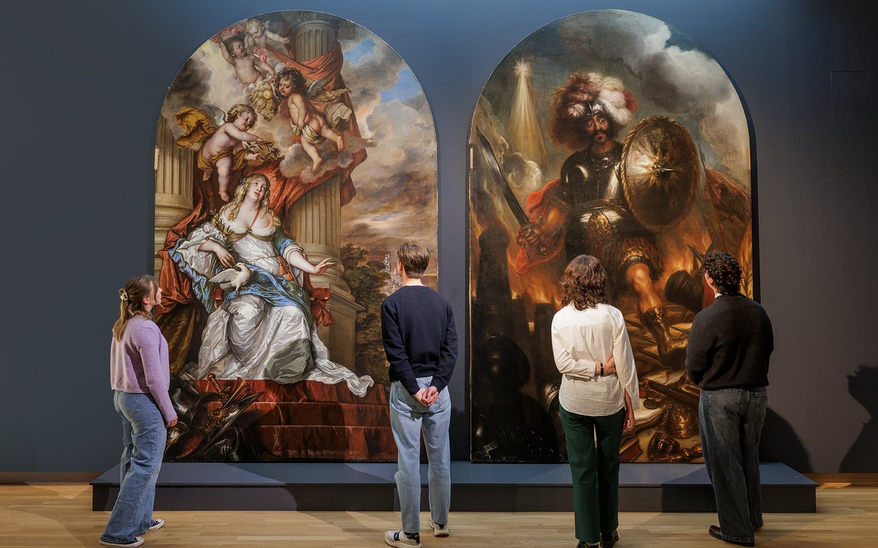 People attending the opening event of the Witt exhibition on April 25, 2025, in a modern gallery space with displayed artworks and ambient lighting.