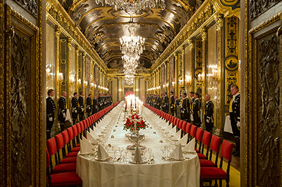 Elegant banquet setting in the Karl XI Gallery at the Royal Palace, with long decorated tables, chandeliers, and guests attending a formal Nobel dinner.